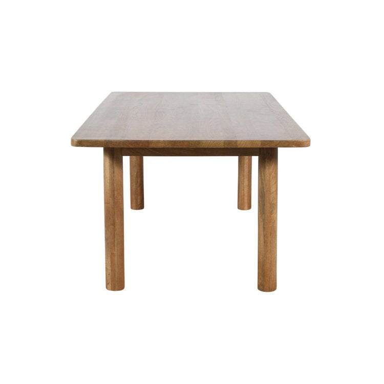Front view of the Bodhi dining table in a light natural mango wood finish featuring a minimalist rectangular top and thick cylindrical legs