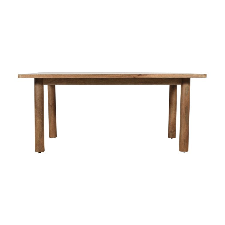 Front view of the Bodhi dining table in a light natural mango wood finish featuring a minimalist rectangular top and thick cylindrical legs