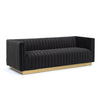 Angled view of Bretz black velvet retro modern sofa with vertical channel tufting