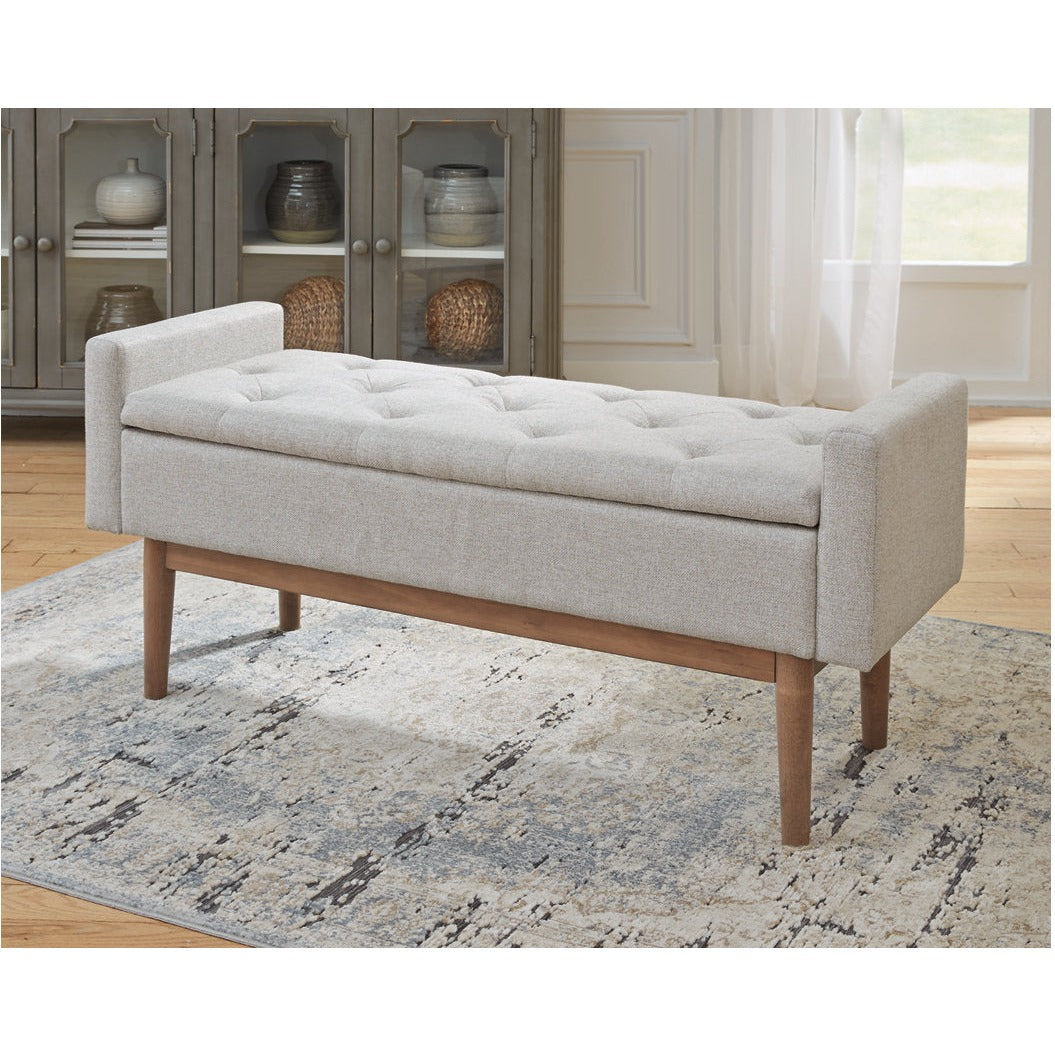 Front view of the Briarson storage bench featuring light gray button-tufted upholstery and natural wood tapered legs