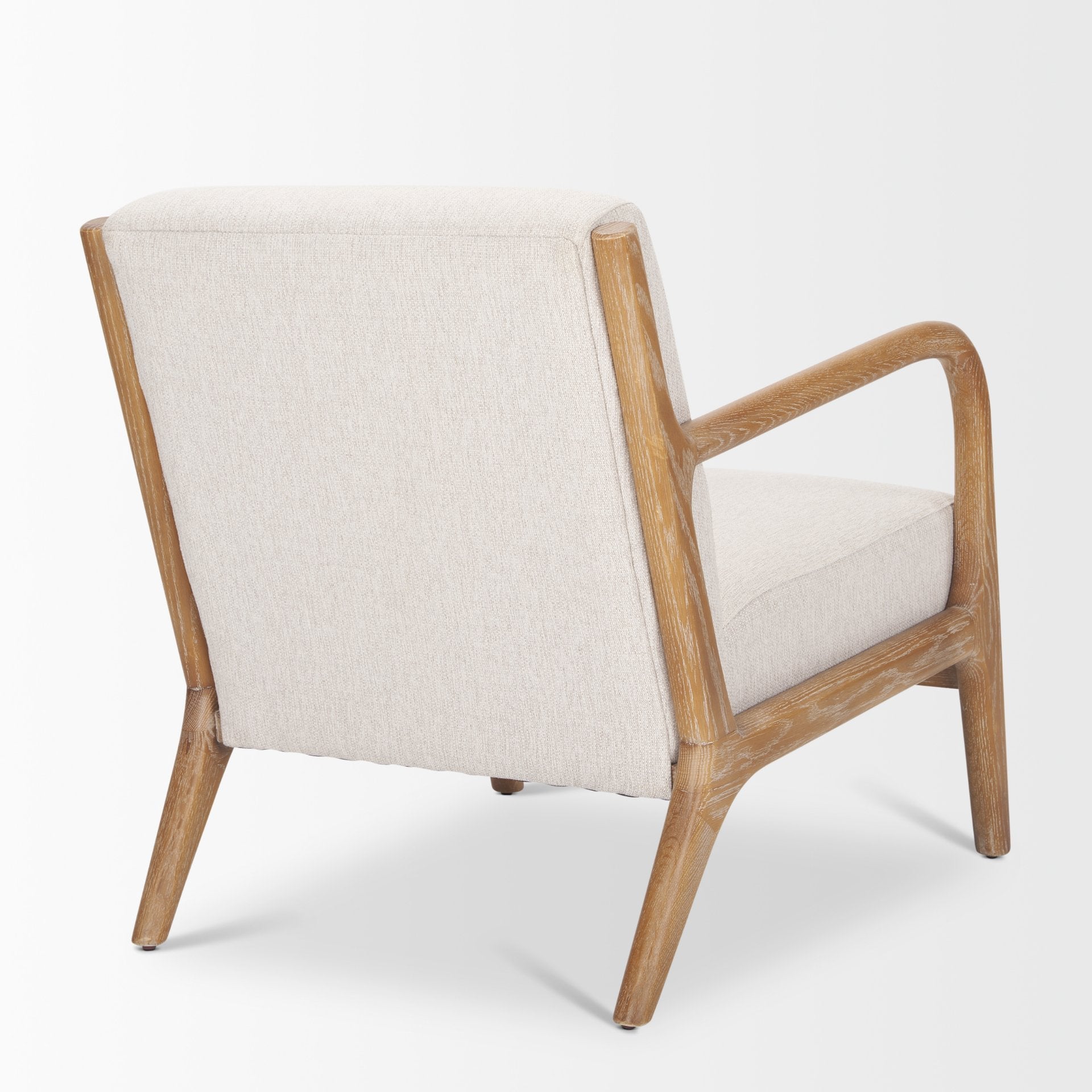 Angled back view of the ivory Cashel chair highlighting the connection between the armrests and frame