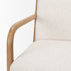 Detailed view of the ivory fabric meeting the oak wood frame at the top corner of the chair