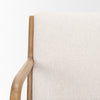 Close-up of the smooth, rounded light oak armrest on the ivory Cashel accent chair