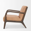 Side profile of the tan leather Cashel chair showing the contrast with the dark wood frame