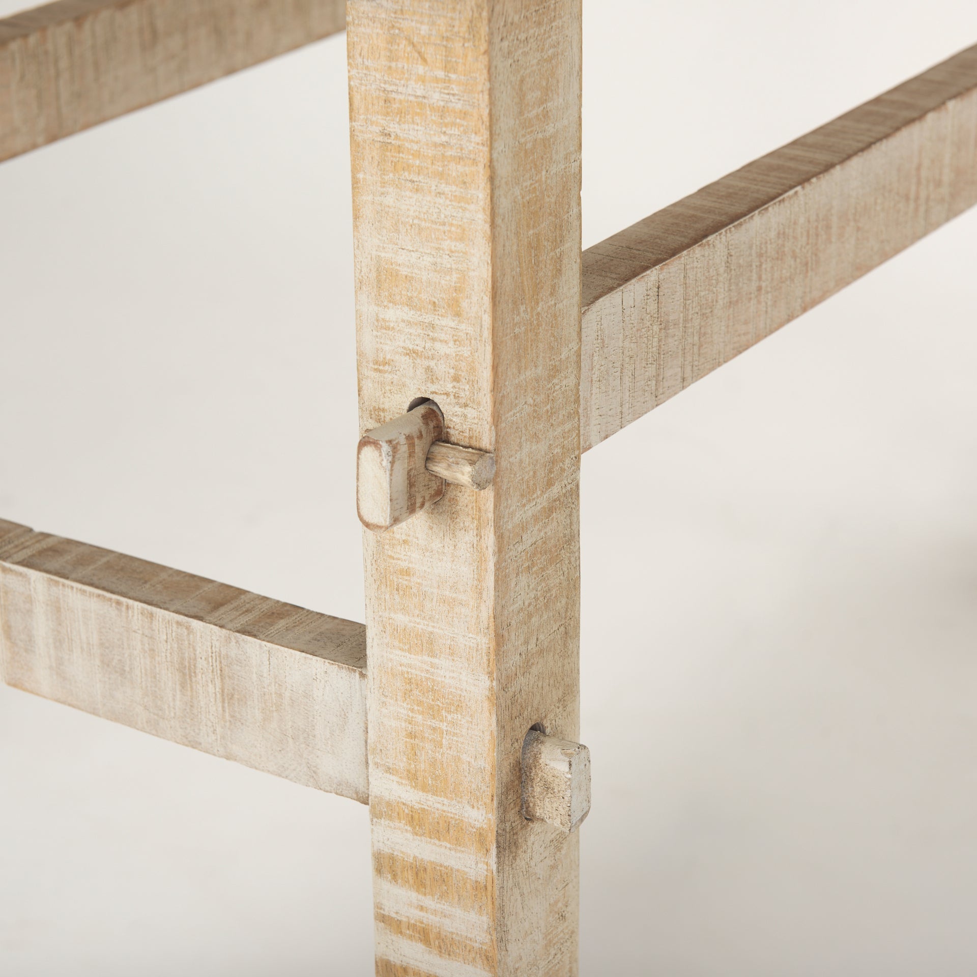 Front view of the Rosie console table in a light natural mango wood finish featuring a minimalist double-tier design