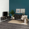 Brass Esagono end table styled next to a modern sofa