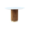 Front view of the Fifi round dining table featuring a sleek white marble top and a decorative fluted wood pedestal base with a gold metal plinth