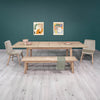 Lifestyle perspective featuring the Gia oak table paired with contrasting black upholstered dining chairs