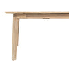 Lifestyle shot featuring the table styled in a bright modern dining room with matching bench and neutral chairs