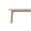 Close-up front perspective highlighting the elegant tapering of the solid wood legs