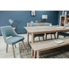Lifestyle perspective showing the Gia bench paired with a matching dining table and upholstered chairs