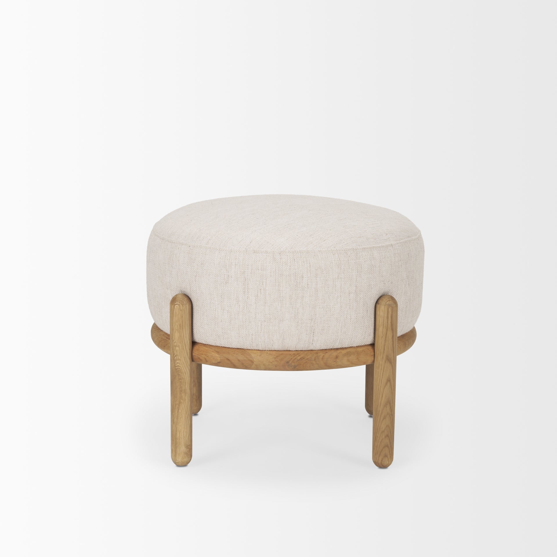 Front three-quarter view of the Gwynn pouf featuring a cream upholstered seat and a curved oak wood frame