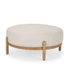 Three-quarter studio view highlighting the low-profile design and elegant material contrast of the Gwynn ottoman
