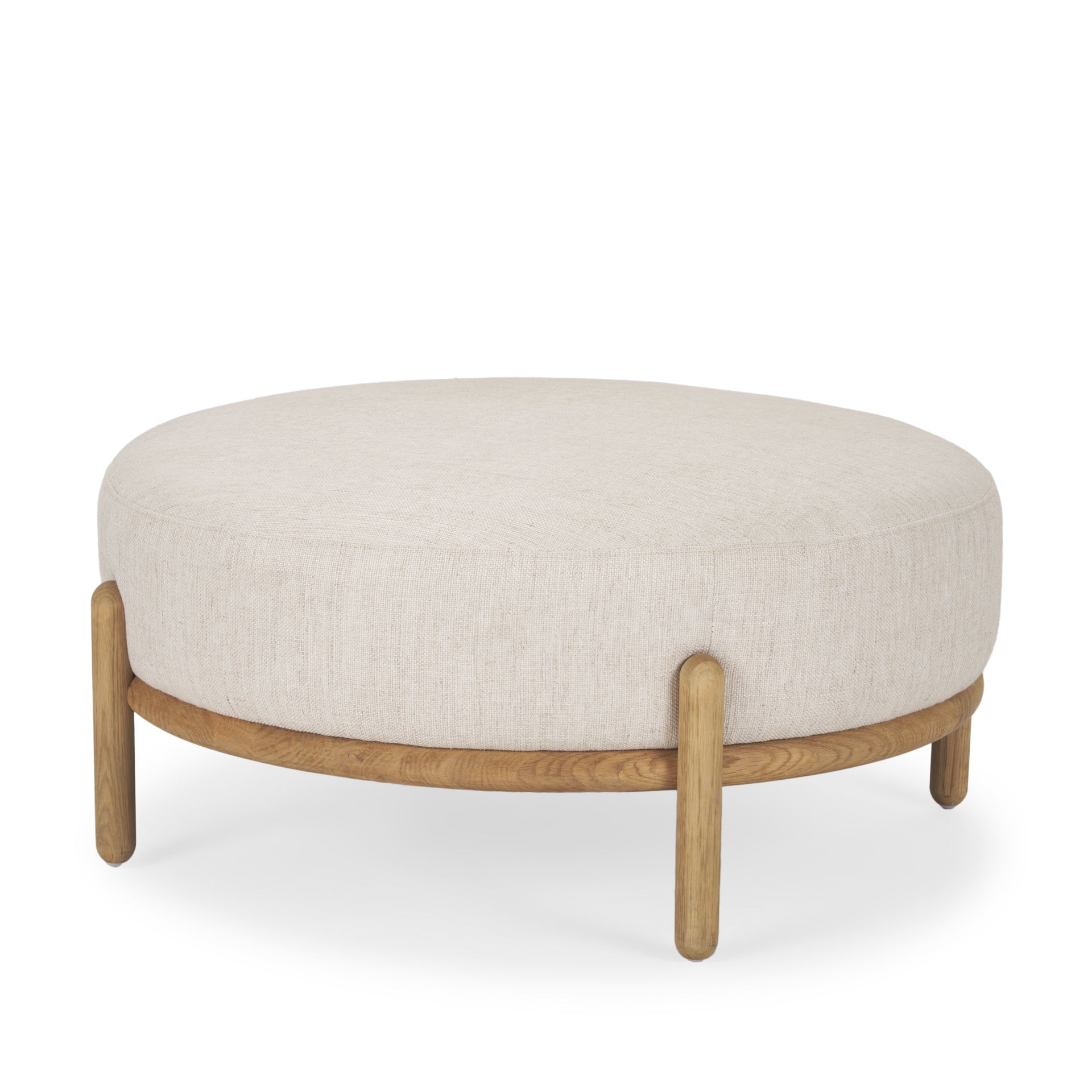 Front three-quarter view of the Gwynn ottoman featuring a cream upholstered seat and a curved oak wood frame
