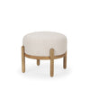 Three-quarter studio view highlighting the low-profile design and elegant material contrast of the Gwynn pouf