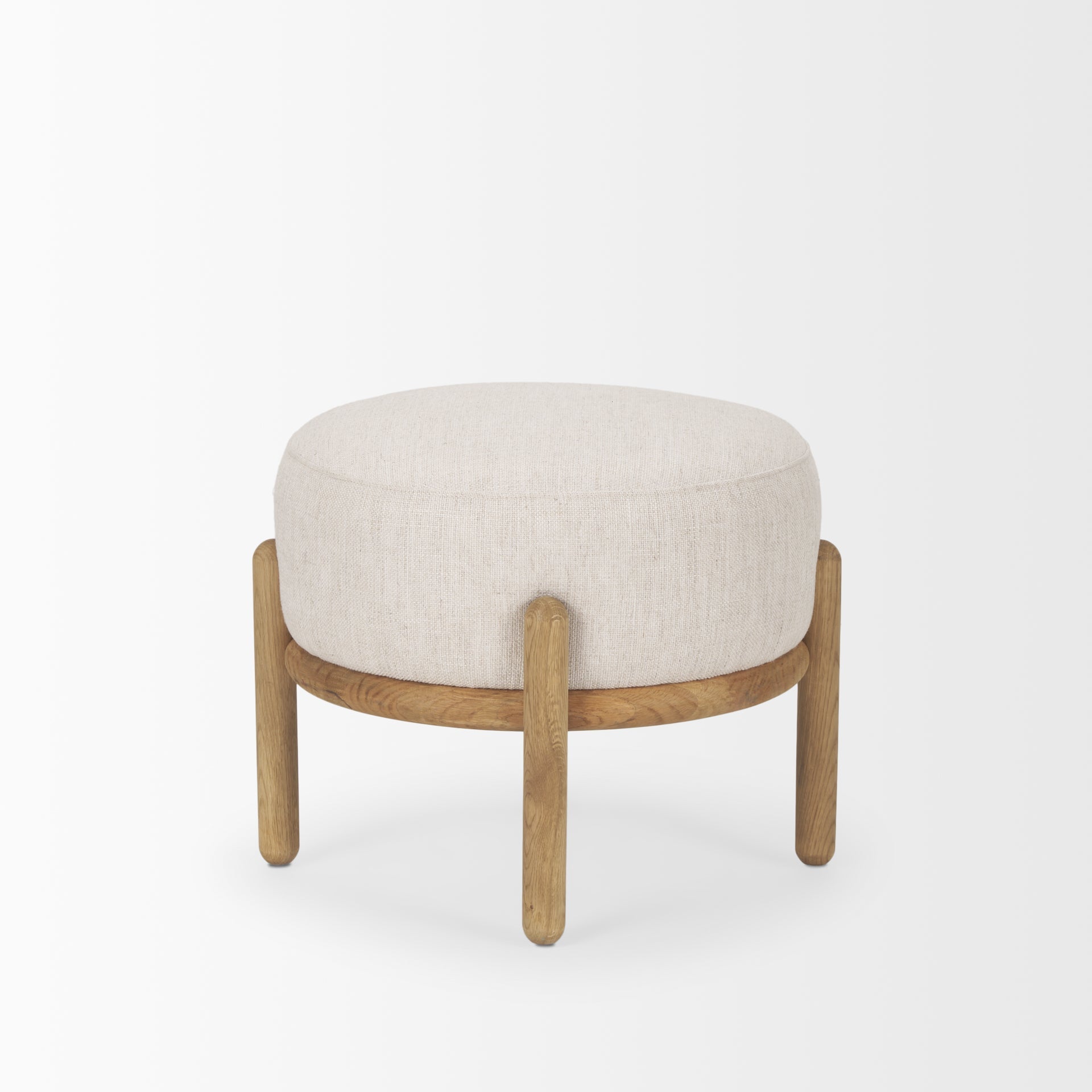 Front three-quarter view of the Gwynn pouf featuring a cream upholstered seat and a curved oak wood frame