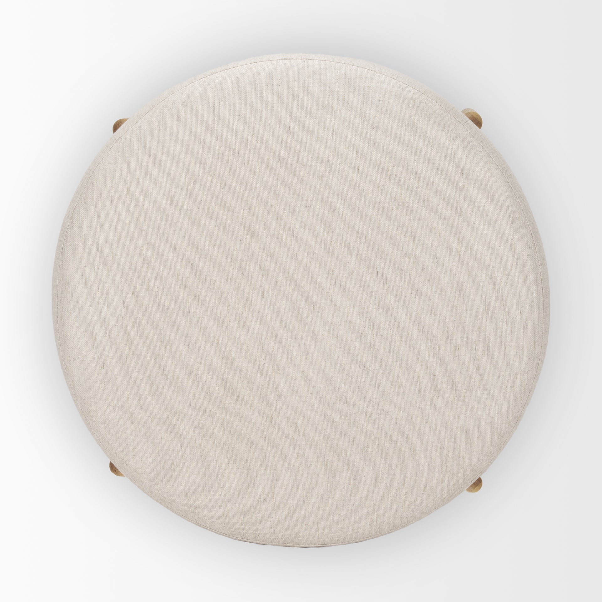 Front three-quarter view of the Gwynn ottoman featuring a cream upholstered seat and a curved oak wood frame