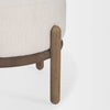 Detailed perspective showing the intersection of the cream fabric seat and the natural wood support frame