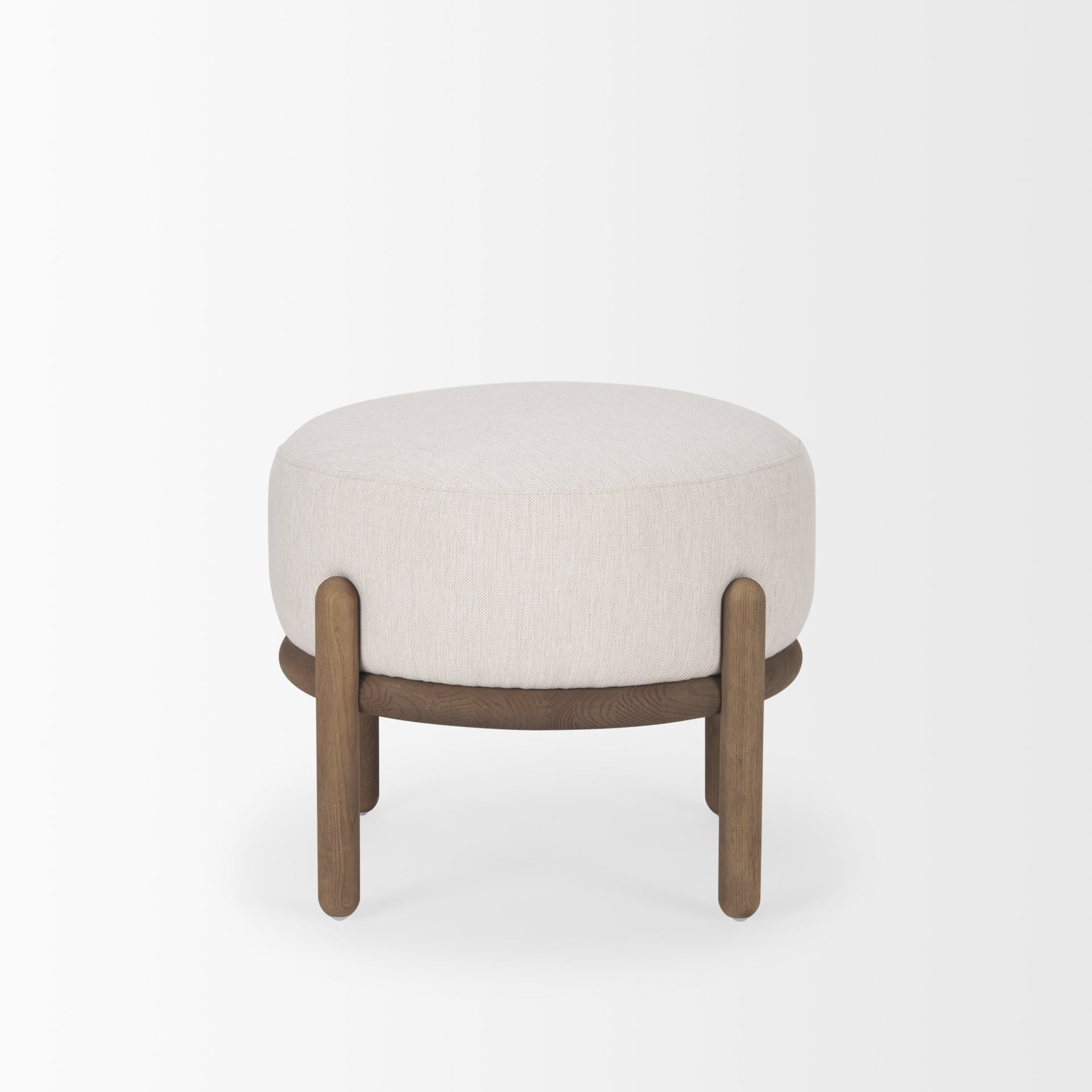 Front three-quarter view of the Gwynn pouf featuring a cream upholstered seat and a curved oak wood frame
