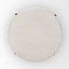 Direct top-down view emphasizing the clean circular lines and neutral cream upholstery of the Gwynn ottoman