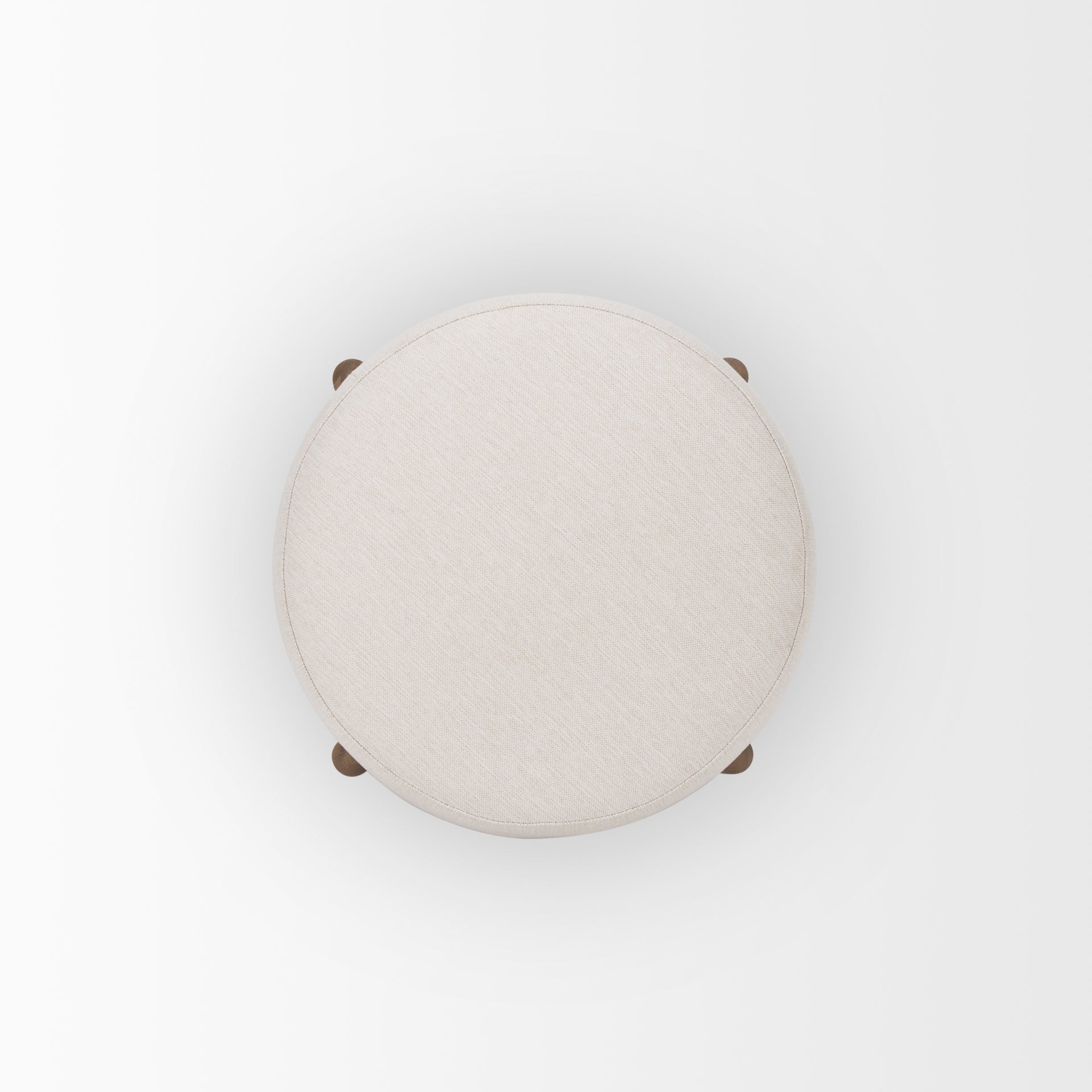 Front three-quarter view of the Gwynn pouf featuring a cream upholstered seat and a curved oak wood frame