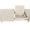 Action shot showing the table opened to reveal the integrated butterfly extension leaf and metal glide mechanism