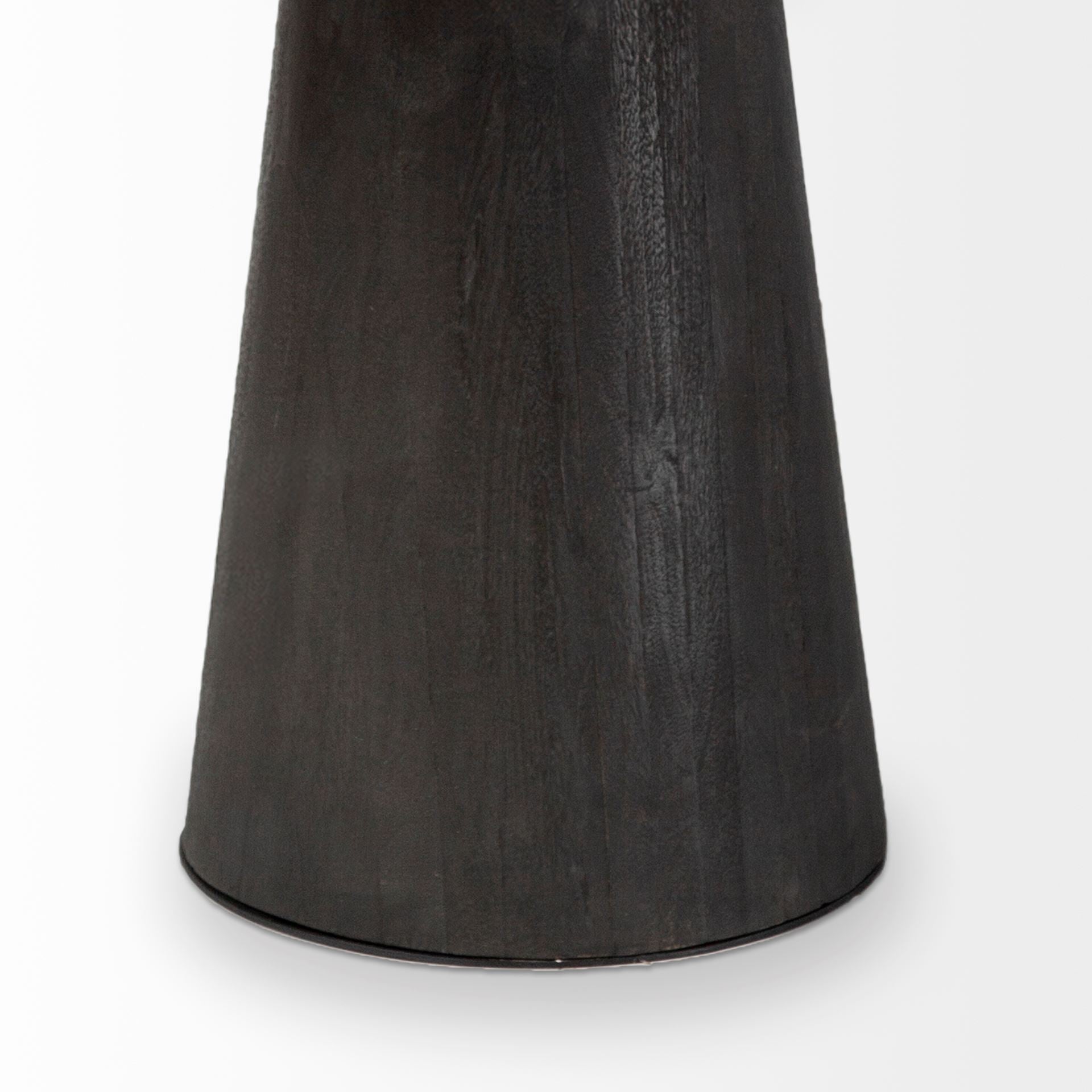 Front view of the Maxwell round dining table featuring a natural wood top and a tapered pedestal base with an antique brass metal neck