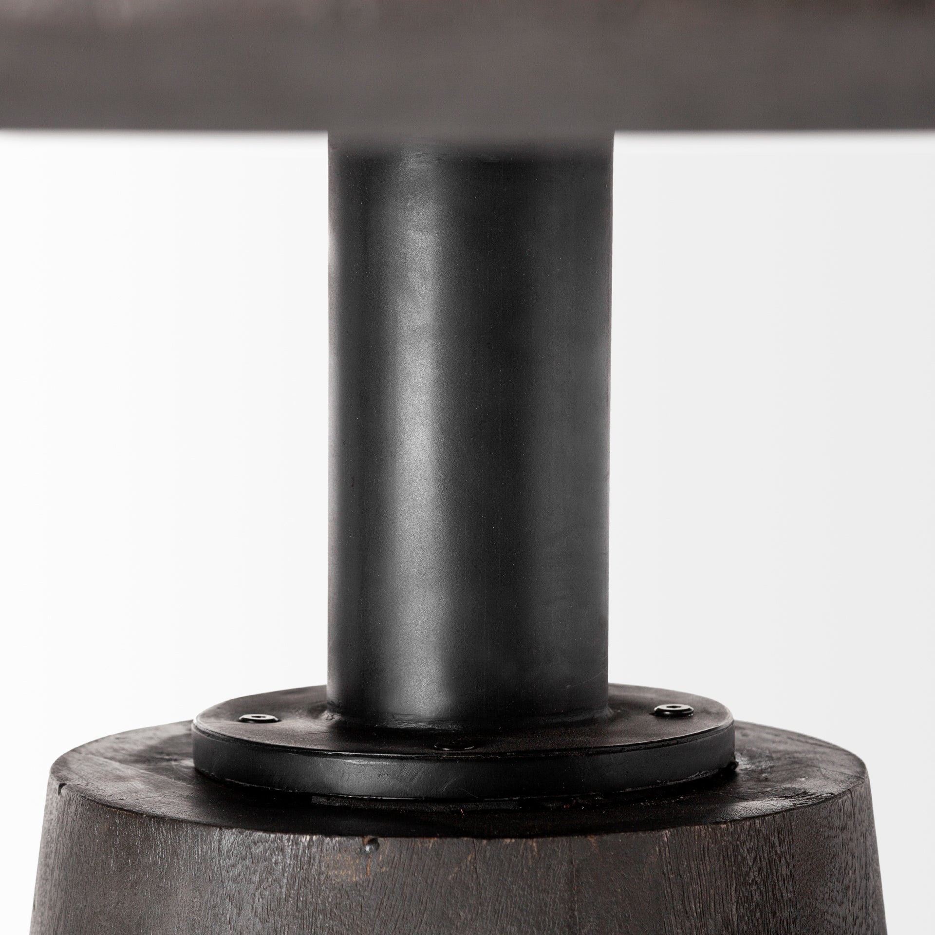 Front view of the Maxwell round dining table featuring a natural wood top and a tapered pedestal base with an antique brass metal neck