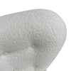 Close-up of the plush white bouclé backrest and the curved wooden frame connection