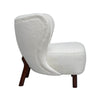 Three-quarter view of the Mellow chair showcasing the smooth arched wooden armrests and deep seat