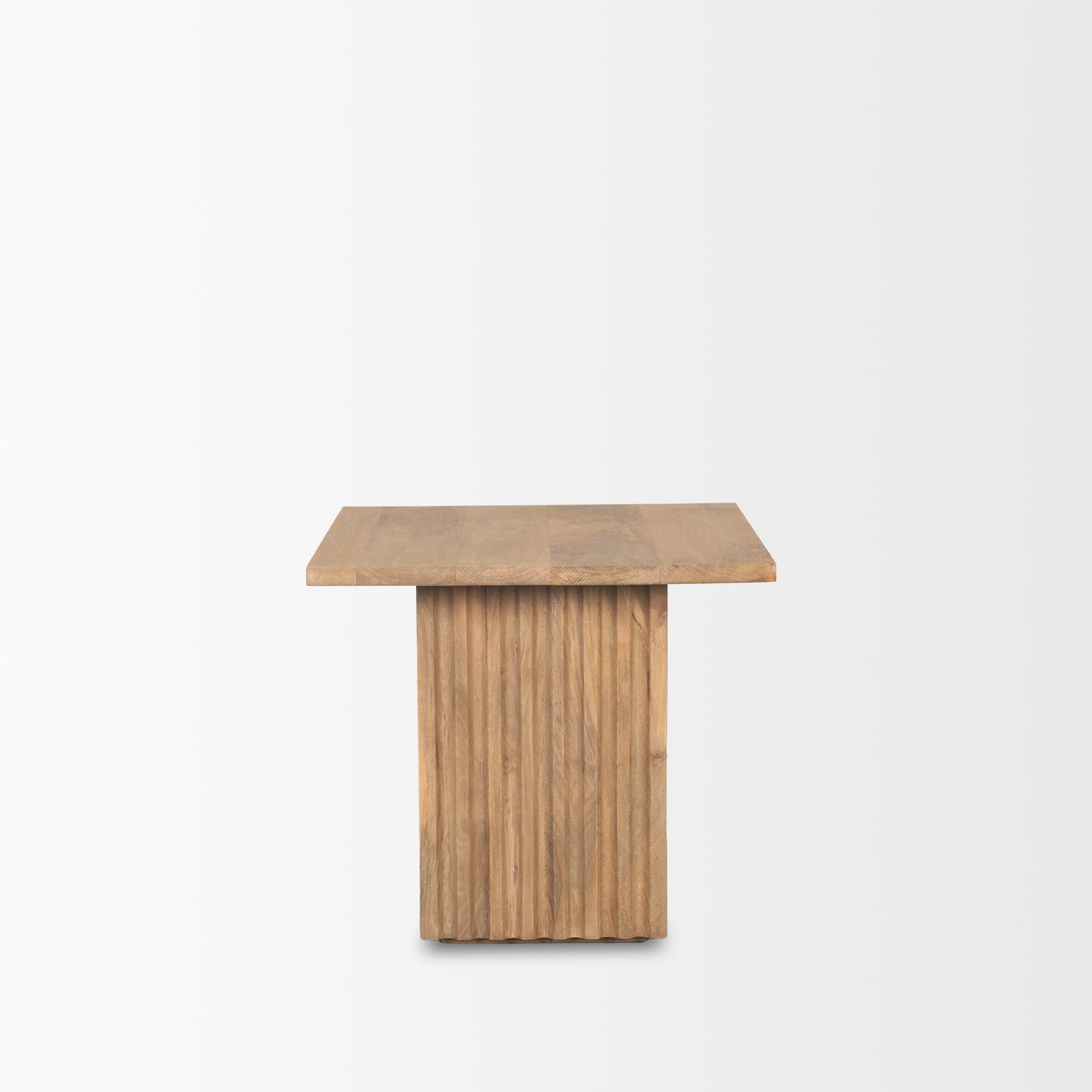 Perspective view of the June side table featuring a square tabletop and a thick square fluted pedestal base in natural mango wood
