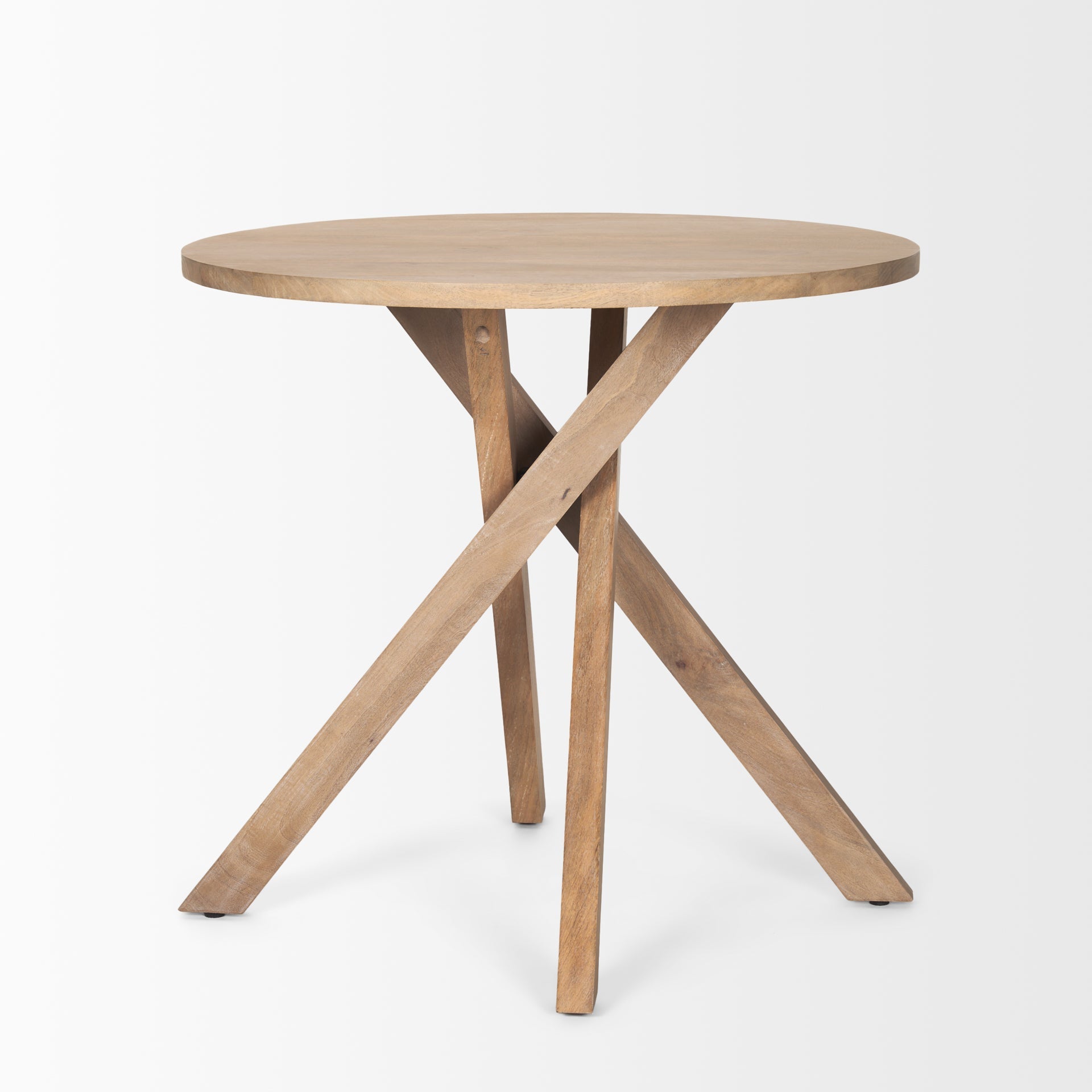 Three-quarter perspective view of the Solana foyer table featuring a circular top and a unique interlocking tripod base in light natural mango wood