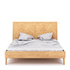 Straight-on studio shot highlighting the natural wood grain and architectural chevron pattern of the headboard