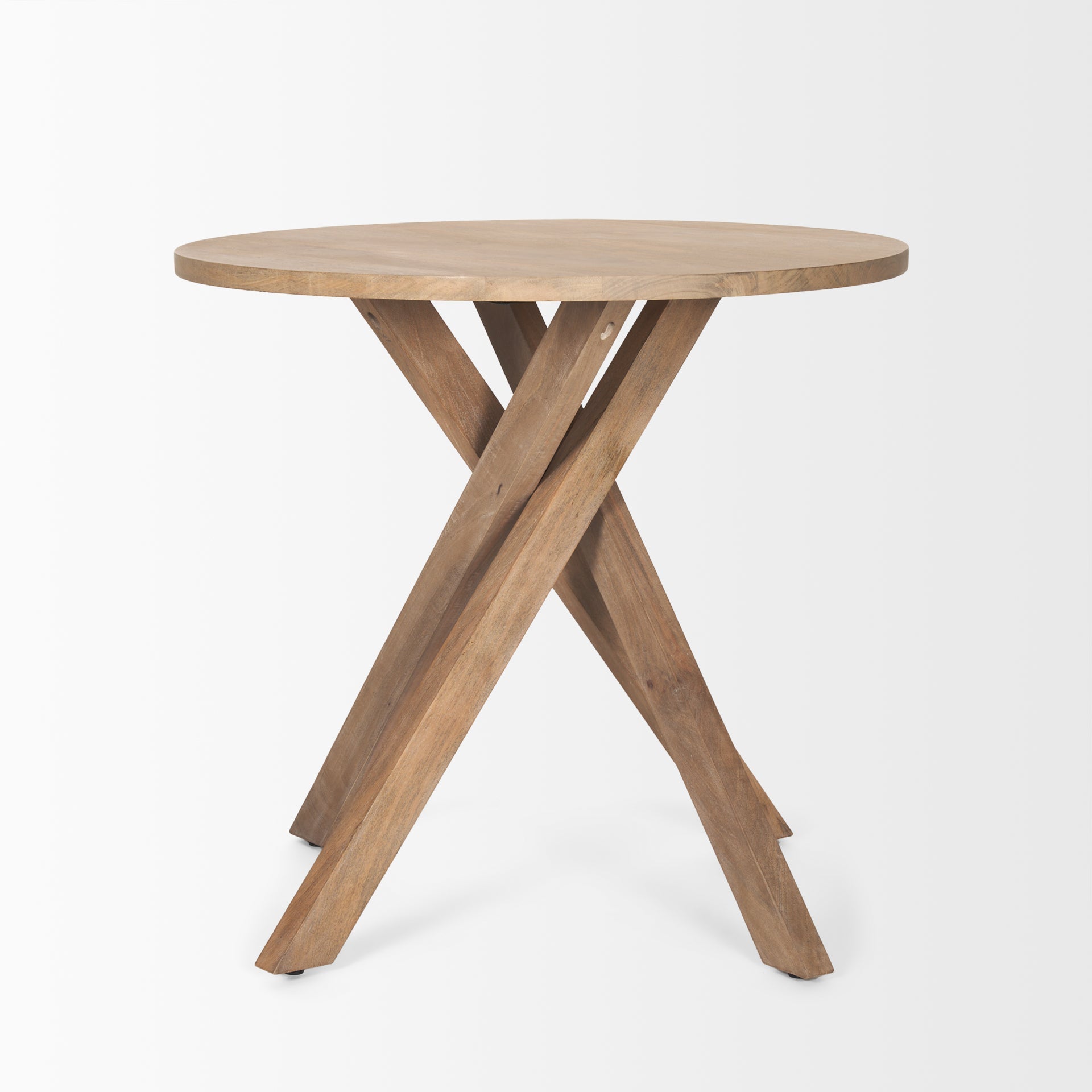 Three-quarter perspective view of the Solana foyer table featuring a circular top and a unique interlocking tripod base in light natural mango wood