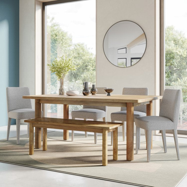 Front view of the Bodhi dining table in a light natural mango wood finish featuring a minimalist rectangular top and thick cylindrical legs
