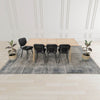 Studio lifestyle view highlighting the table as a central focal point styled with neutral furniture and greenery