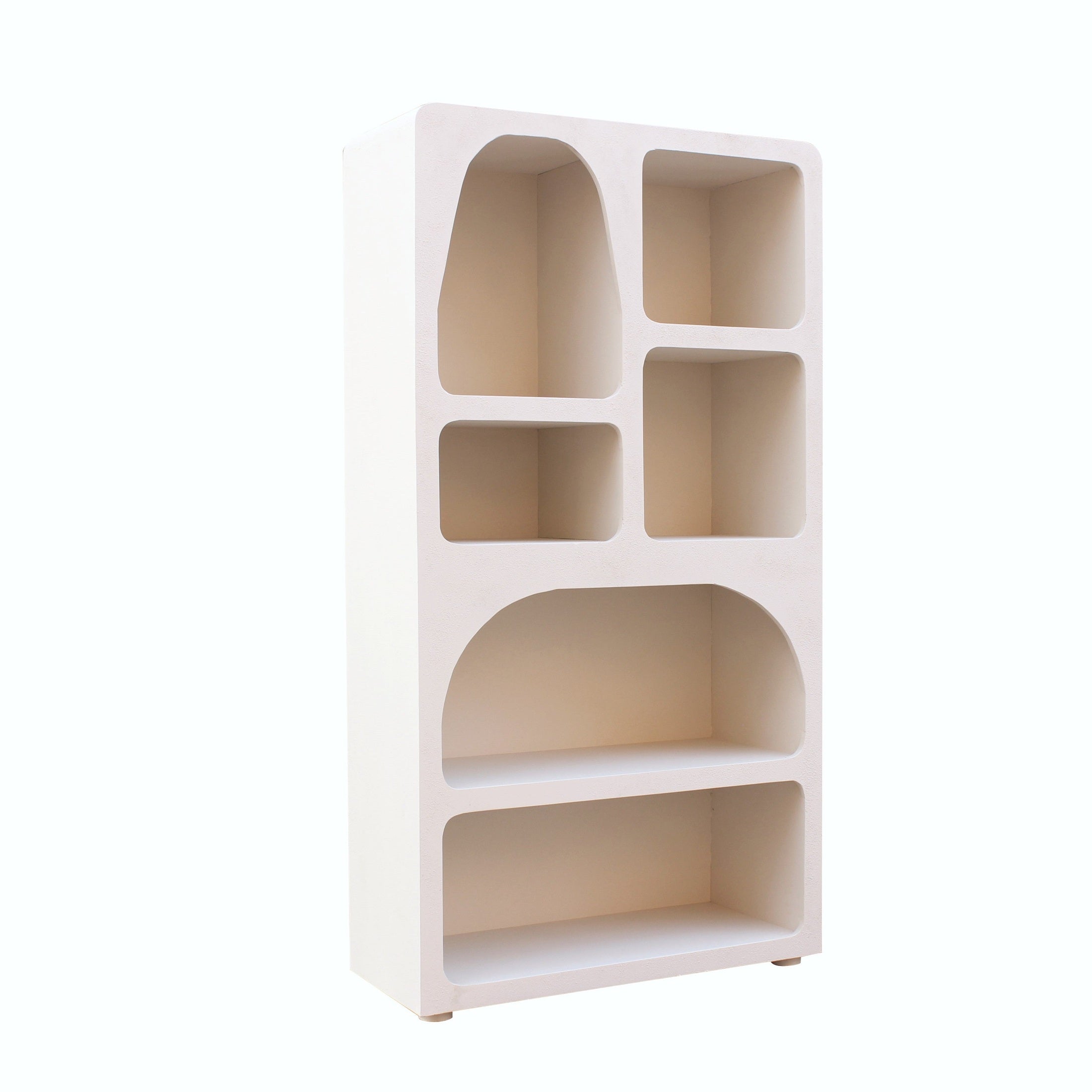 Straight-on front view of the Inga bookshelf featuring a sculptural asymmetrical layout with arched and rectangular display niches in a matte white finish