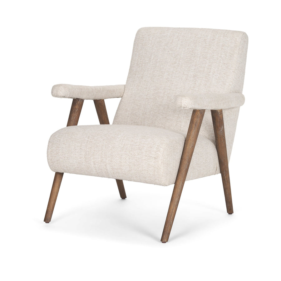 Three-quarter view of the Nico armchair showcasing its angled backrest and architectural wood frame