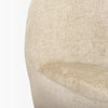 Macro close-up of the oatmeal-toned bouclé fabric texture on the side of the Beverly chair.