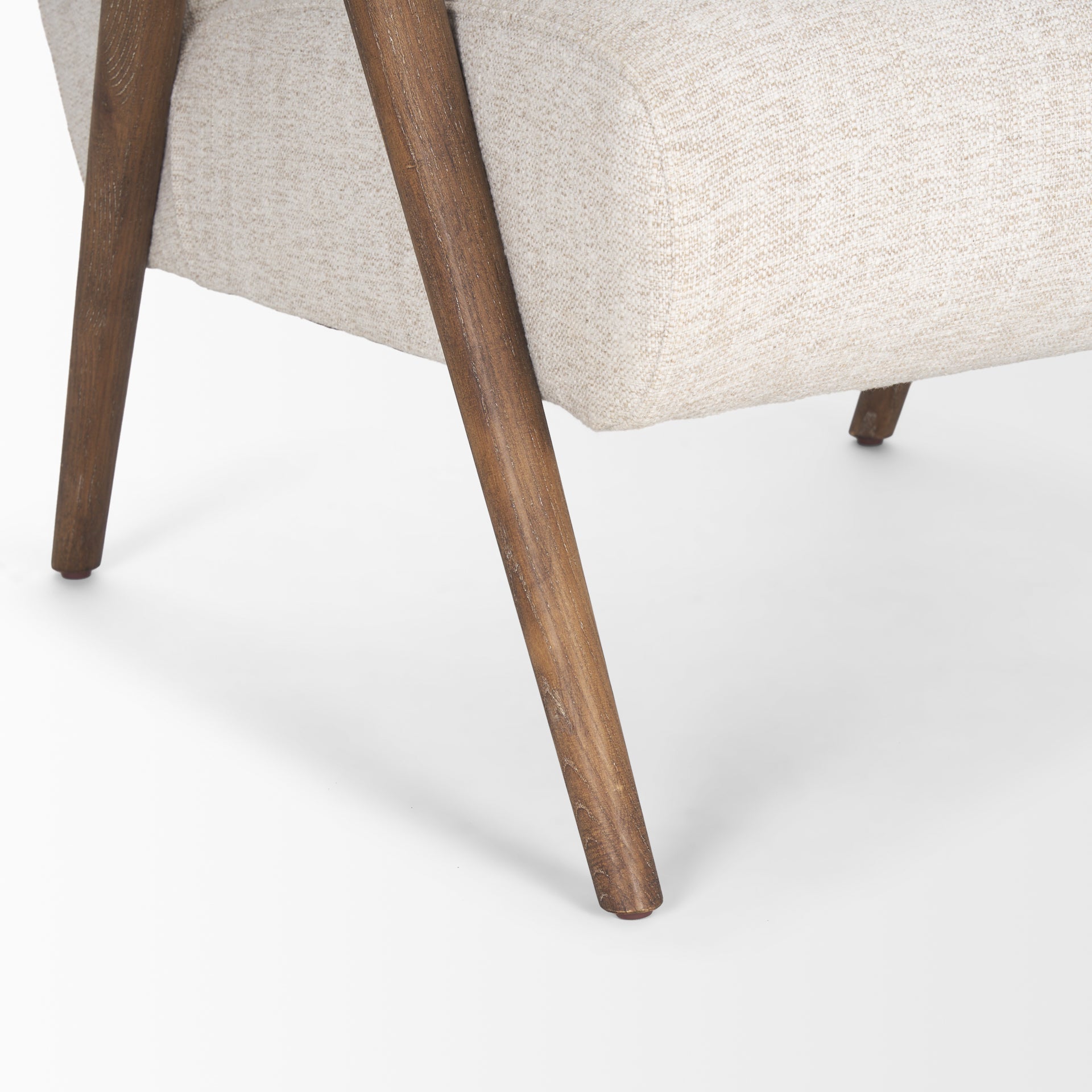 Front view of the Nico Accent Chair featuring oatmeal-colored textured fabric and dark-stained tapered wood legs