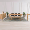 Lifestyle shot featuring the oak console styled in a contemporary dining space alongside a matching table and bench set