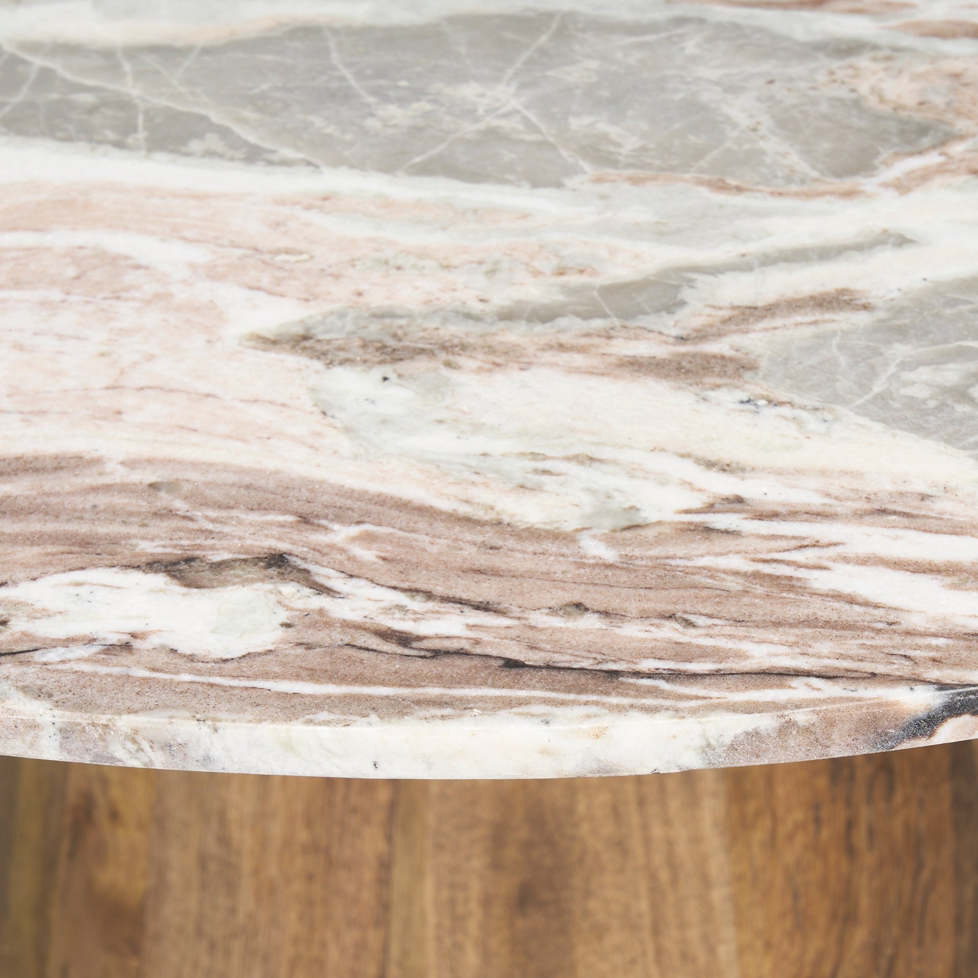 Front view of the Allyson round dining table featuring a white marble top and a solid mango wood tapered pedestal base