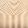 Straight-on detail shot of the elegant vertical arched carving on the natural wood door panel