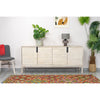 Lifestyle shot featuring the Gemini sideboard styled with minimalist greenery and modern lighting in a bright interior