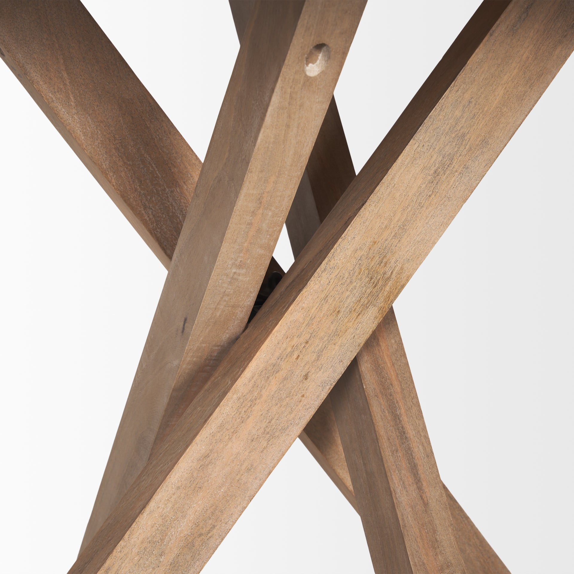 Three-quarter perspective view of the Solana foyer table featuring a circular top and a unique interlocking tripod base in light natural mango wood