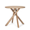 Three-quarter perspective view of the Solana foyer table featuring a circular top and a unique interlocking tripod base in light natural mango wood