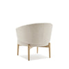 Rear angled perspective showing the seamless upholstery finish and sturdy four-leg oak base