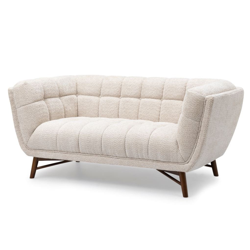 Three-quarter front view of the Stella Loveseat in cream boucle with a walnut-stained wood base