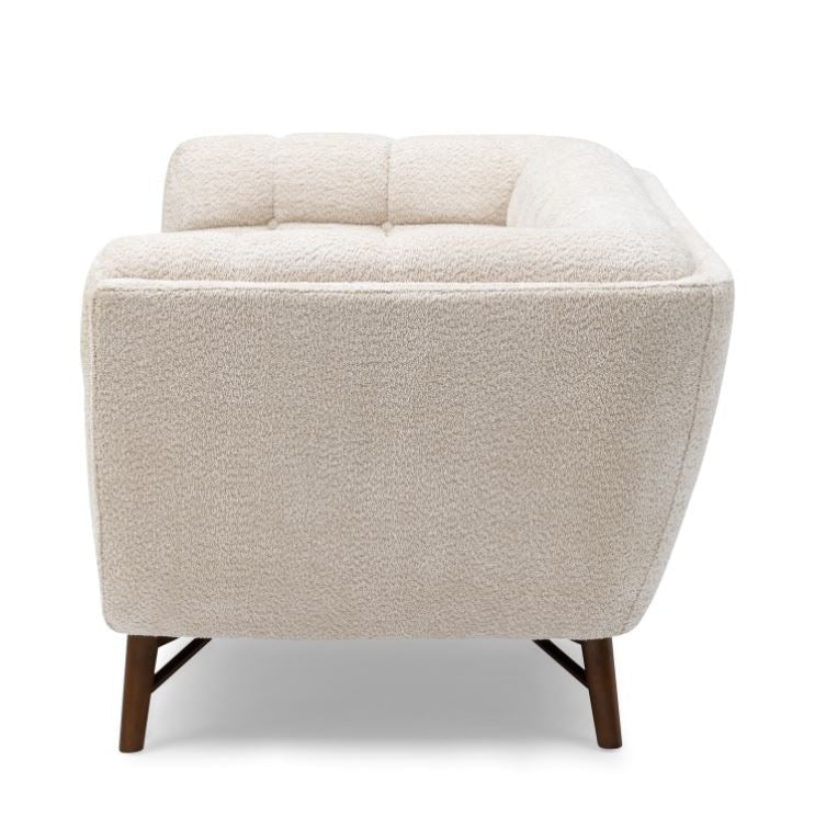 Three-quarter front view of the Stella Loveseat in cream boucle with a walnut-stained wood base