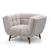 Three-quarter perspective of the grey Stella chair highlighting the wrap-around tufted backrest